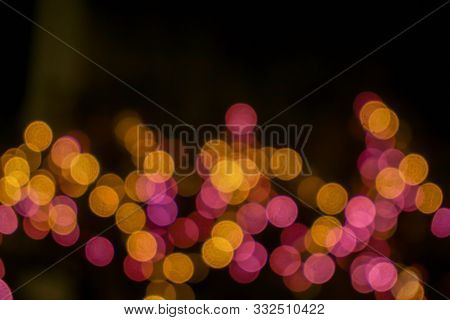 Closeup Abstract Blurred And Bokeh Of Reflection Lighting Of Pink And Yellow Led Light Bubs On Black