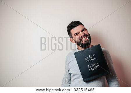 Black Friday Image With Space For Text. Bkack Friday Sale Flat Lay. Black Friday Bag. Angry Bearded
