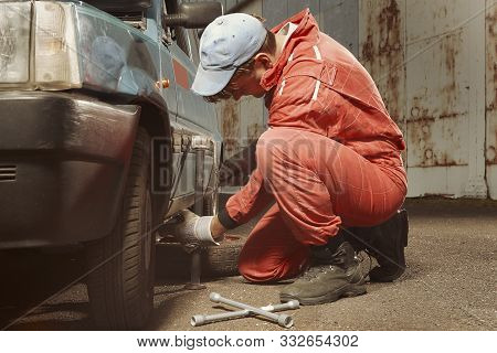 Cute Man In Red Overall Tunning His Lovely Retro Car