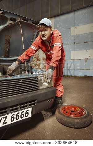 Cute Man In Red Overall Tunning His Lovely Retro Car