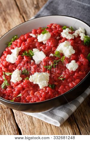 Orzotto With Beets, Parmesan, Goat Cheese And Herbs Close-up On A Plate. Vertical
