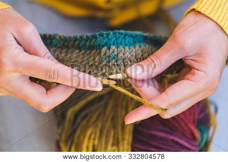 Female Hands Close-up. Young Woman Is Knitting. Knitting Needles And Threads. Multi-colored Yarn. Ha