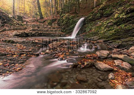 Autumn Mountain Waterfall Stream In The Rocks With Colorful Red Fallen Dry Leaves, Natural Seasonal 
