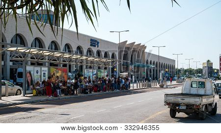 Gudja, Malta - July 24, 2019. Tourists At The Bus Station In Front Of The Malta International Airpor