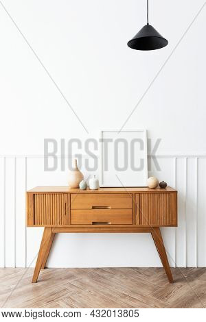 Pciture frame on a wooden sidebboard table