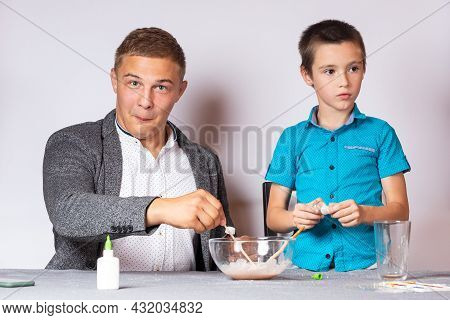 Chemistry Education And Training Concept. Close-up Of A Boy And His Dad Doing A Home Chemical Experi