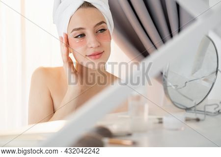 Anti-aged Treatment. Sensual Woman. Morning Beauty Care. Smiling Lady Towel On Head Enjoying Reflect