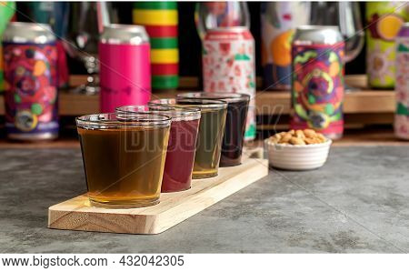 Craft Beer Tasting, Sour Fruit Ipa, Lager, Stout, And Pale Ale. Bar With Different Cans In The Blurr