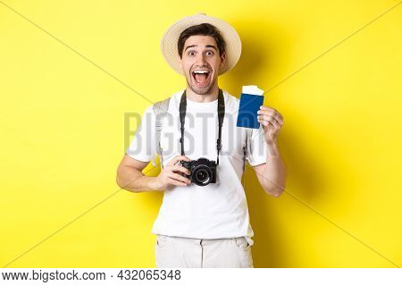 Travelling, Vacation And Tourism Concept. Excoted Tpirost Showing Passport With Tickets, Holding Cam