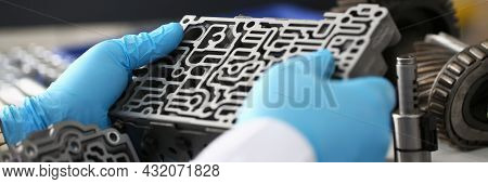 Man In Gloves Holds Car Gearbox Closeup