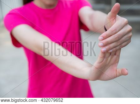 Close Up Of Woman Doing Stretching Fingers Before Workout. Wrist And Hand Exercises Can Reduce The C