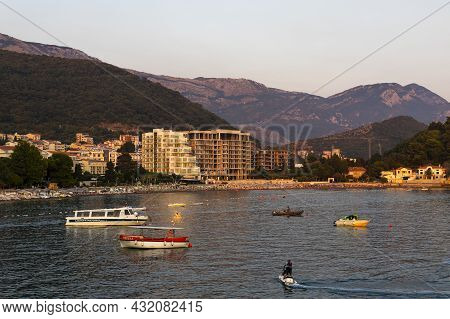 Petrovac ,montenegro - August 23, 2021: View Of The Boats At Sea , Public Beach And Petrovac Town Wi
