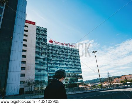 Lisbon, Portugal - Feb 8, 2018: Bank Worker Near The Headquarter Of Santander Totta Bank Headquarter
