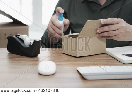 A Man Press Alcohol Bottle Spray For Clean Product Cleaning Before Starting Work To Prevent The Spre