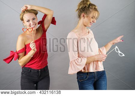 Happy Two Women Holding Paper Decoration Photo Booth Mask Glasses On Stick, Having Fun. Wedding, Bir