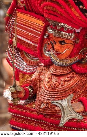 Kannur, India - December 3, 2019: Theyyam perform during temple festival in Kannur, Kerala, India. Theyyam is a popular ritual form of worship in Kerala, India