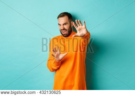 Disgusted Man Cringe And Extending Hands In Protection, Begging For Mercy, Looking At Something With