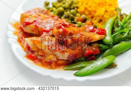Chicken Breast In A Tomato And Red Pepper Sauce With Spiced Long Grain Rice And Crushed Minted Peas