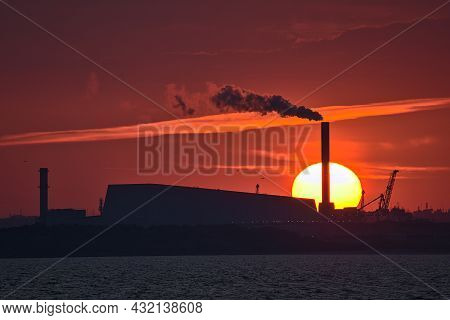Beautiful Telephoto View Of Epic Orange Sunset Over Dublin Port And Sun Aligned With Covanta Plant (