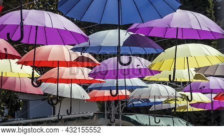 The Street Is Decorated With Colorful Umbrellas,a Cheerful Canopy From The Sun.