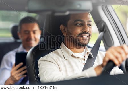 transportation, vehicle and people concept - happy smiling indian male driver driving car with passenger