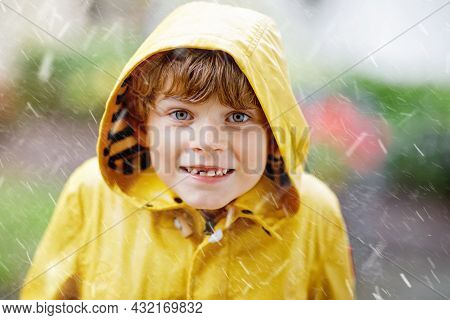 Beautiful Little Kid Boy On Way To School Walking During Sleet, Heavy Rain And Snow With An Umbrella