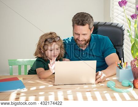 Homeschooling And Estudy. Back To School. Father And Son Use Computer At Home.