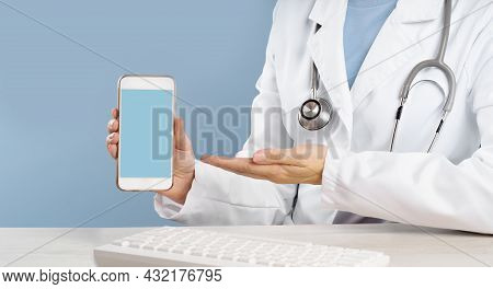 Doctor Holding A Mockup Smartphone With An Medical App
