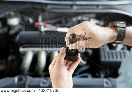 Technician Check Old Spark Plug Coil With Burn Marks On Engine Coil In Maintenance Service Of Gasoli
