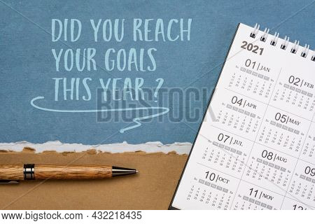 Did you reach your goals this year? Handwriting on a handmade paper with a pen and 2021 desktop calendar. Goal setting concept.