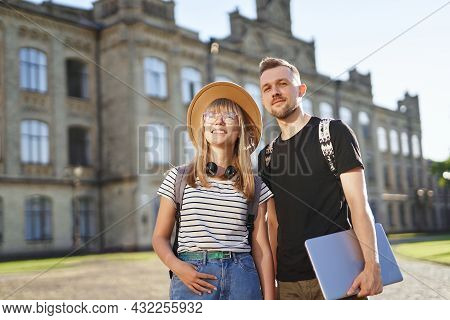 Cheerful High School Students Couple Smiling. Two Cheerful Students, Male And Female, With Backpacks