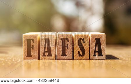 The Word Fafsa In A Notebook On White Table With Office Tools. Business Concept.