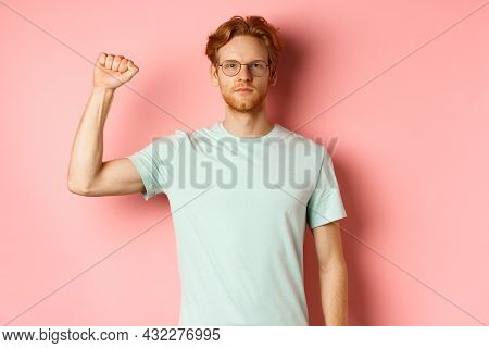 Confident Redhead Man Standing United With Black Lives Matter Movemet, Showing Raised Fist And Looki