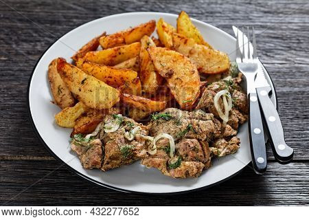 Grilled Pork Shoulder Steaks With Roasted Potato Wedges Seasoning With Paprika And Dill On A Plate O