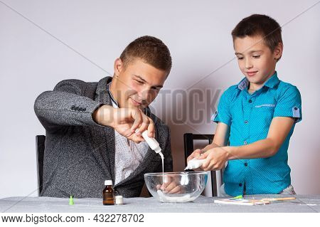 Chemistry Education And Training Concept. Close-up Of A Boy And His Dad Doing A Home Chemical Experi