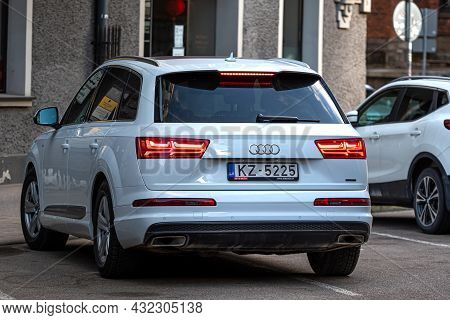 Riga, Latvia - 7 April, 2021: White Luxury Suv Audi Q7 Parked On The Side Of The Street, View From B