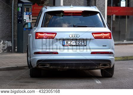 Riga, Latvia - 7 April, 2021: White Luxury Suv Audi Q7 Parked On The Side Of The Street, View From B