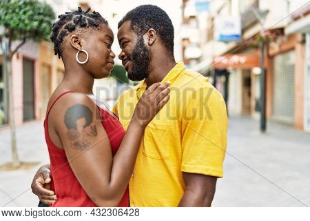 Young afircan american couple smiling happy and hugging at the city.