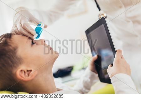 Closeup Of Doctor Pouring Eye Drops In Eye Her Little Patient.
