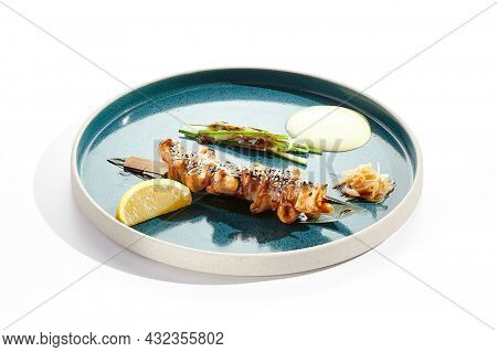 Japanese bbq - skewer yakitori with squid and teriyaki sauce. Grilled calamari on bamboo stick in Japanese style. Bbq menu for asian restaurant. Yakitori on white background
