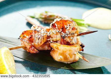 Japanese yakitori with skewers shrimp and teriyaki sauce. Grilled prawns  on bamboo stick in Japanese style. Bbq menu for asian restaurant. Prawn Yakitori on white background
