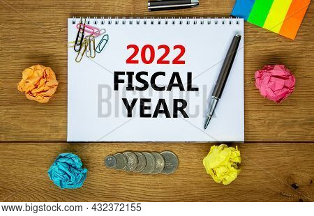2022 Fiscal New Year Symbol. White Note, Words 2022 Fiscal Year On Beautiful Wooden Table, Colored P