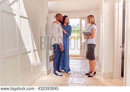 Couple Viewing Potential New Home With Female Realtor