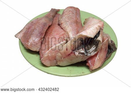 Gutted Ocean Perch. With No Fish Head, Prepared For Further Cooking, On Green Plate, Isolated On Whi