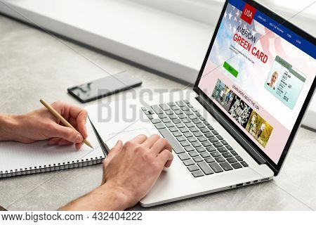 Man With Laptop With United States Permanent Resident Card Website