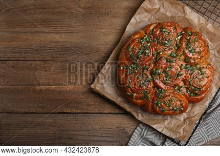 Traditional Ukrainian Garlic Bread With Herbs (pampushky) On Wooden Table, Flat Lay. Space For Text