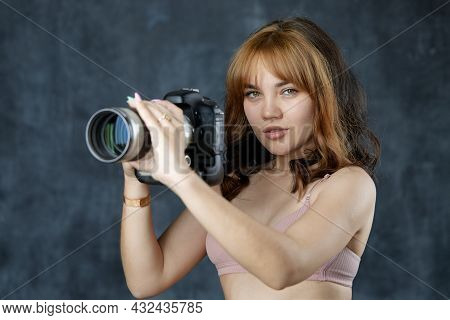A Beautiful Girl Holds A Flashbulb In Her Hands. Photo Accessories. Teaching Photography How To Use 