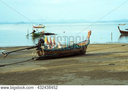 Fisherman's Fishing Boat On Sand At A Fishing Village Beach,stranded Fishing Boat After The Sea Has 