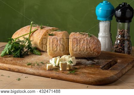 Freshly Baked Cheese Roll. White Roll And Cheese Diced. Salt And Pepper In Quilted Flasks. Sliced Br