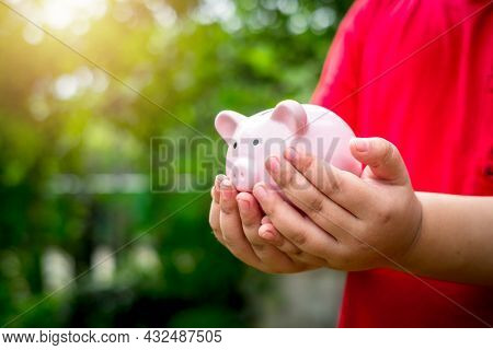 Little Boy Hand Holding Piggy Bank With Copy Space,saving, Charity, Family Finance Plan Concept, Fun